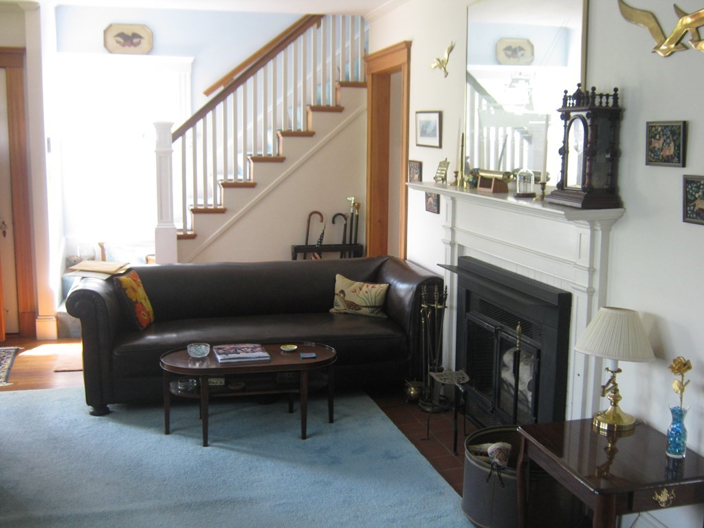 4 Old Salem Road Marblehead, MA 01945 - Photo 4 of 12 a living room with furniture a fireplace and a flat screen tv