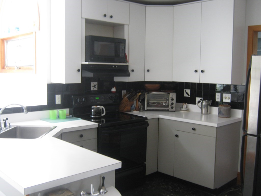 4 Old Salem Road Marblehead, MA 01945 - Photo 6 of 12 a kitchen with a sink and cabinets