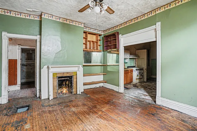 an empty room with a fireplace and cabinet
