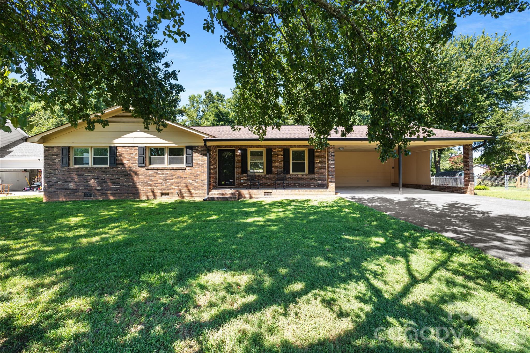 a front view of a house with yard and green space