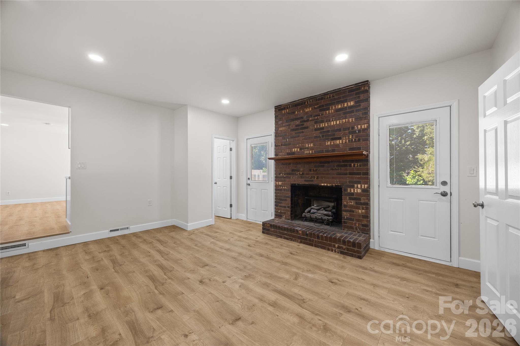 168 Mooreland Road Mooresville, NC 28117 - Photo 13 of 32 a view of an empty room with window and fireplace