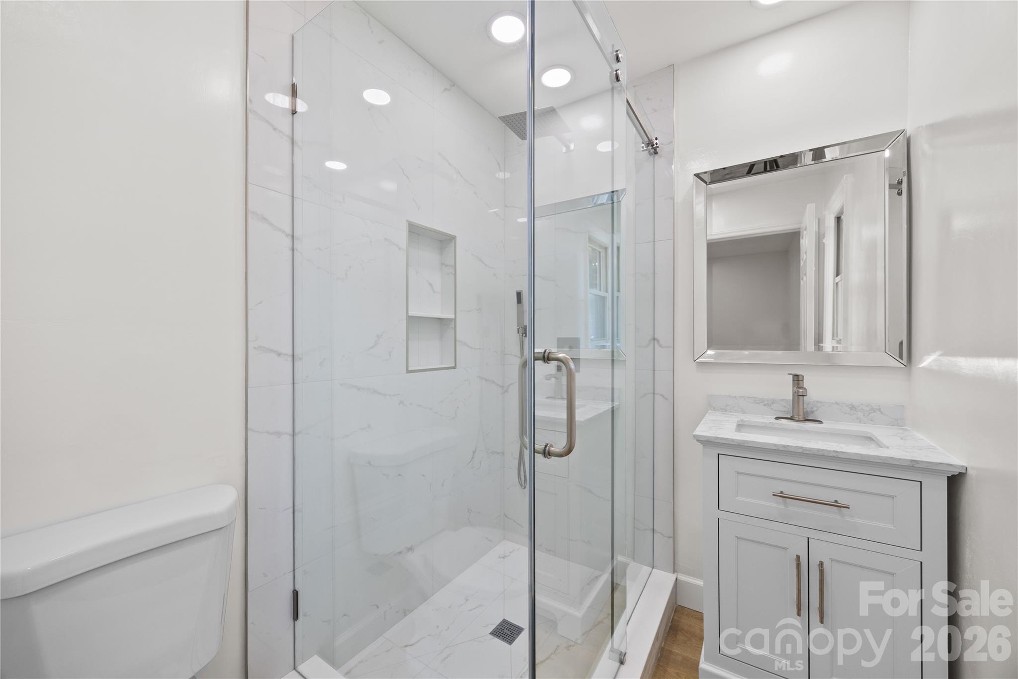 168 Mooreland Road Mooresville, NC 28117 - Photo 16 of 32 a bathroom with a shower sink vanity and mirror