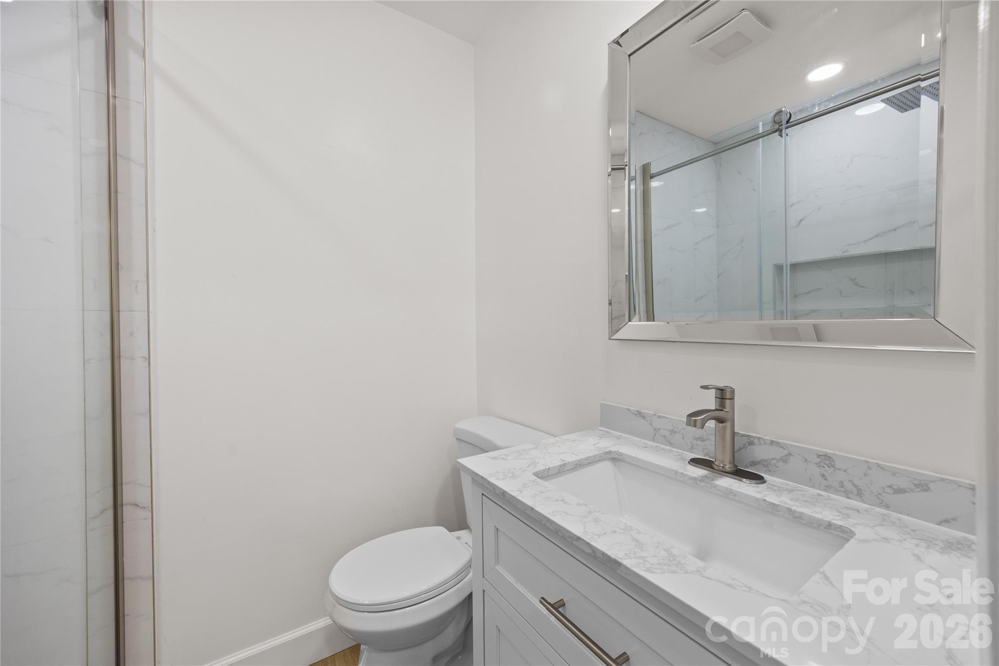 168 Mooreland Road Mooresville, NC 28117 - Photo 20 of 32 a bathroom with a sink a toilet and a mirror