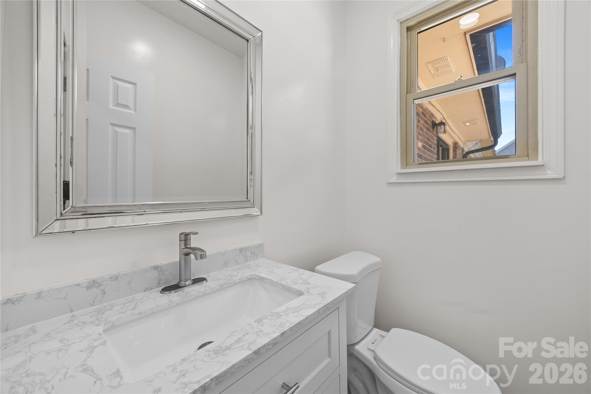 168 Mooreland Road Mooresville, NC 28117 - Photo 22 of 32 a bathroom with a granite countertop sink mirror vanity and toilet