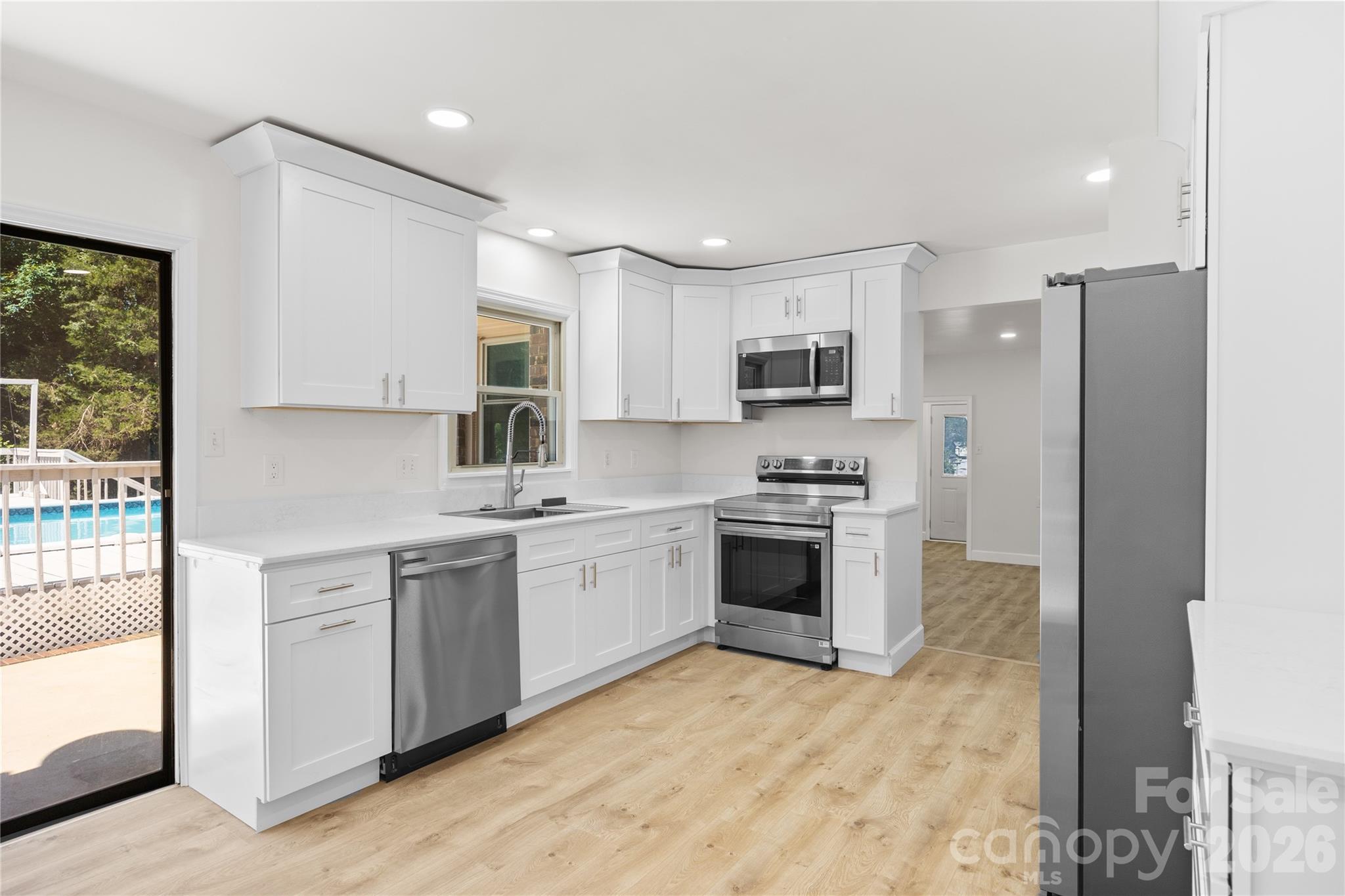 168 Mooreland Road Mooresville, NC 28117 - Photo 7 of 32 a kitchen with stainless steel appliances granite countertop a stove top oven a sink and a refrigerator