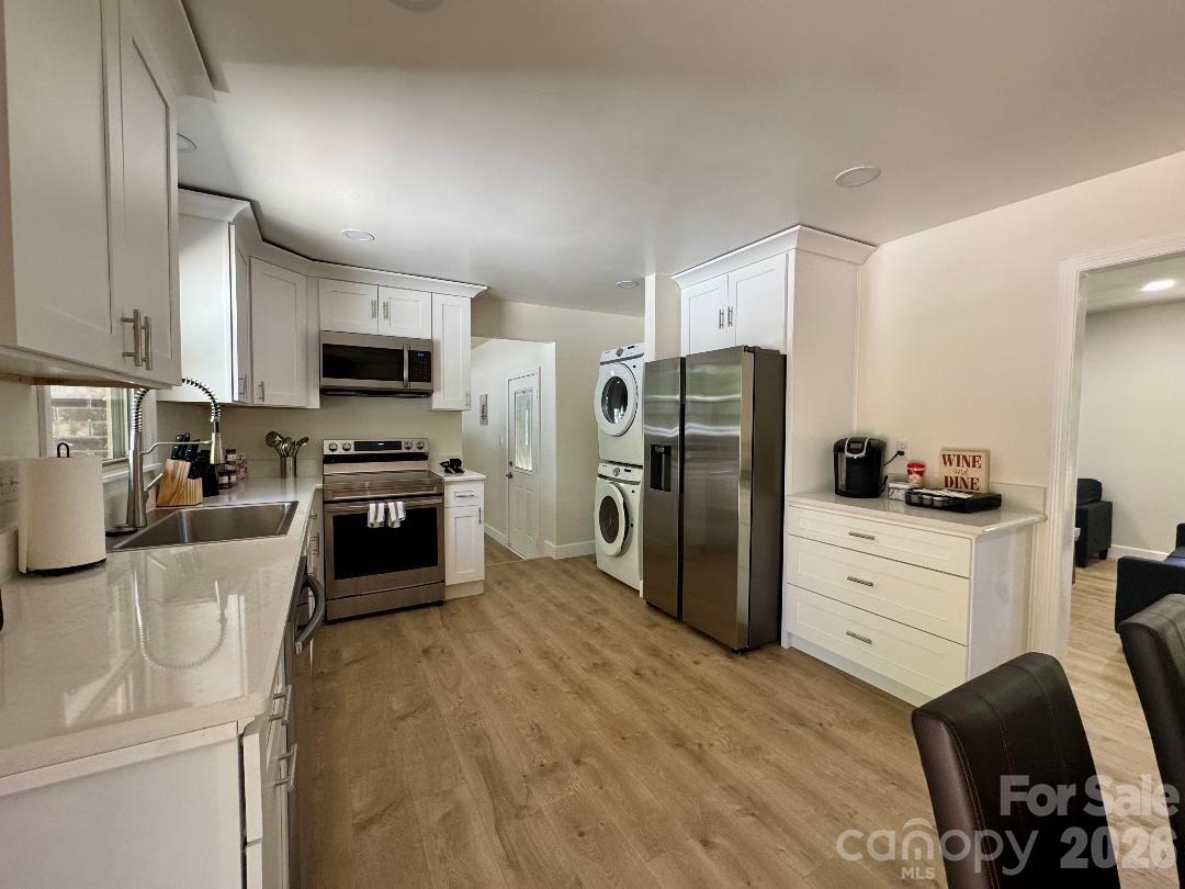 168 Mooreland Road Mooresville, NC 28117 - Photo 8 of 32 a kitchen with a refrigerator a stove top oven a sink and dishwasher