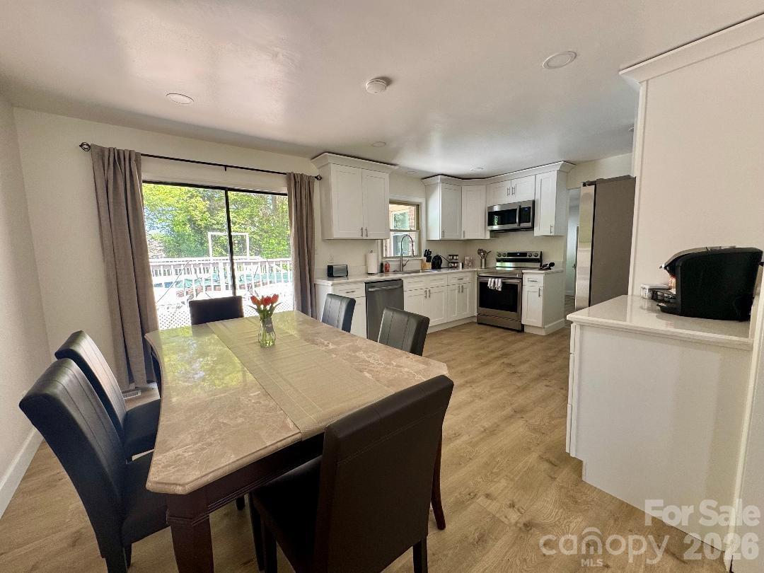 168 Mooreland Road Mooresville, NC 28117 - Photo 10 of 32 a living room with stainless steel appliances granite countertop furniture a fireplace a large window and a rug