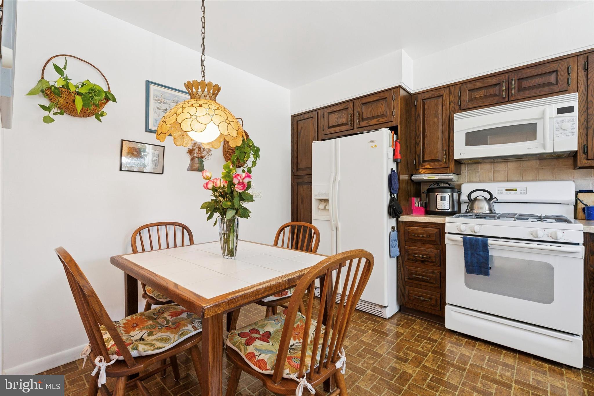 9204 Burbank Road Philadelphia, PA 19115 - Photo 12 of 43 a table and chairs in a kitchen