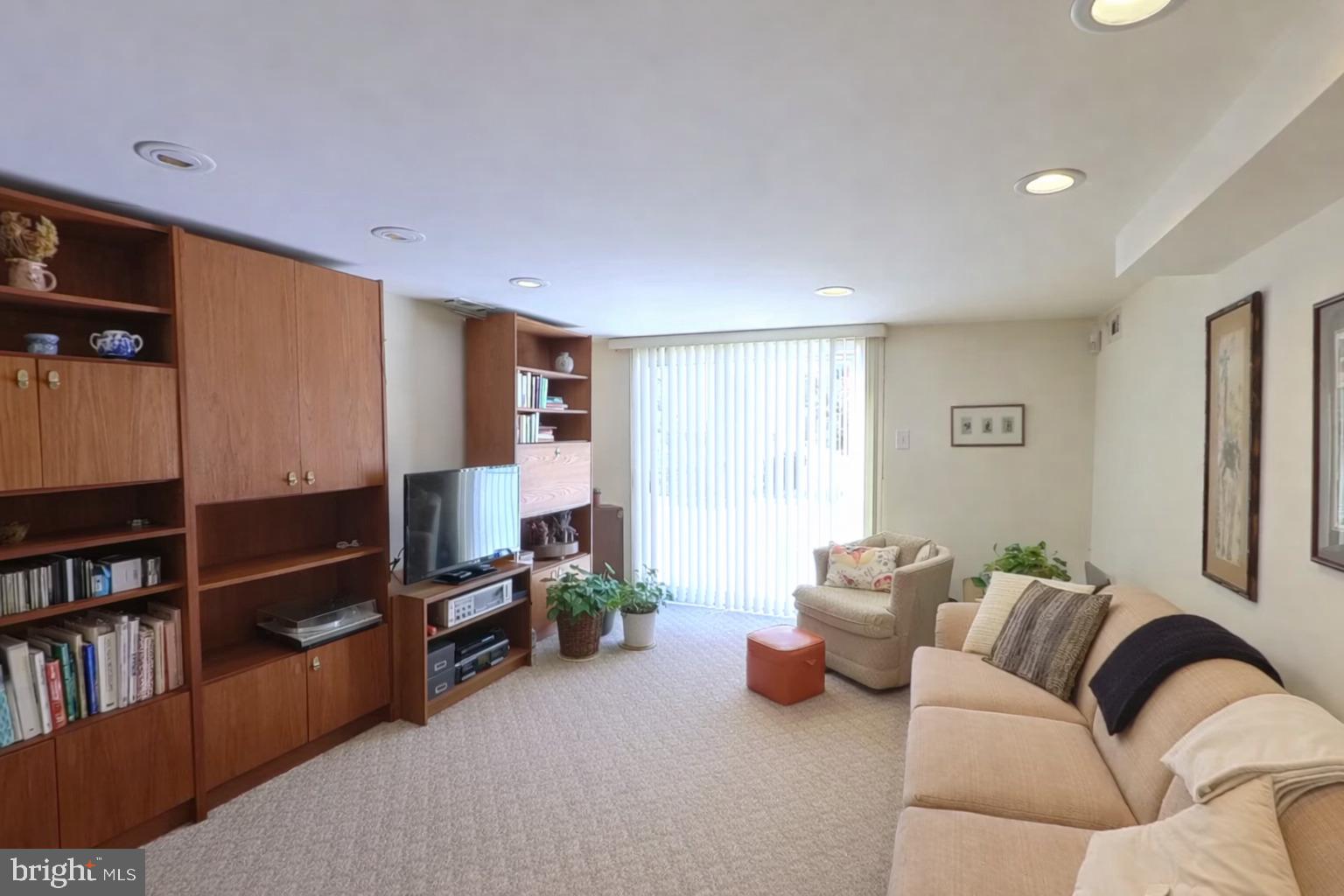 9204 Burbank Road Philadelphia, PA 19115 - Photo 8 of 43 a living room with furniture and a flat screen tv