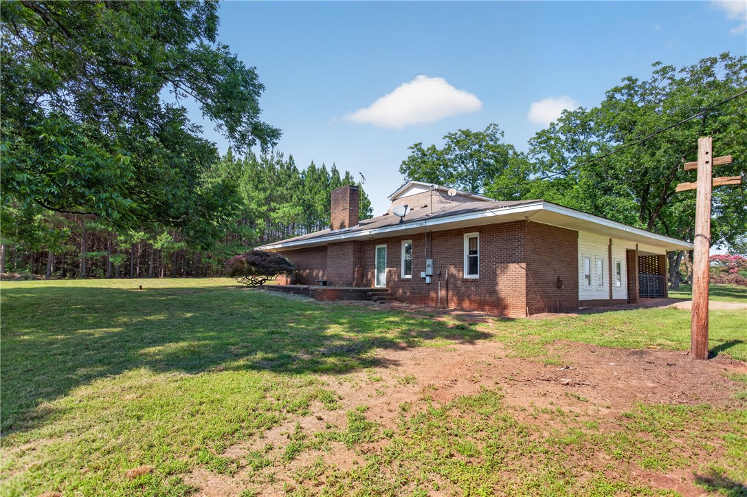 1412 Simpson Road Pendleton, SC 29670 - Photo 45 of 48 A classic brick exterior offers enduring appeal with a vast surrounding lawn and mature trees.