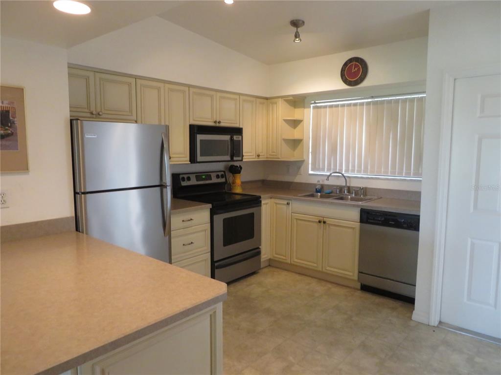 1360 Rio De Janeiro Avenue, Unit 117 Punta Gorda, FL 33983 - Photo 11 of 20 a kitchen with a sink appliances and cabinets