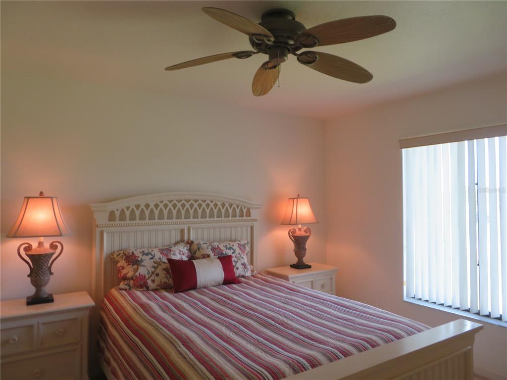 1360 Rio De Janeiro Avenue, Unit 117 Punta Gorda, FL 33983 - Photo 15 of 20 a bedroom with a bed and wooden floor