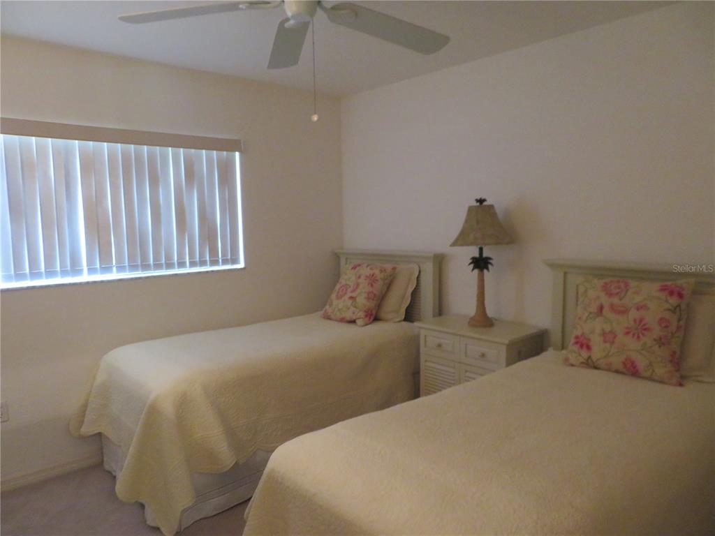 1360 Rio De Janeiro Avenue, Unit 117 Punta Gorda, FL 33983 - Photo 18 of 20 a bedroom with two beds and painting on the wall
