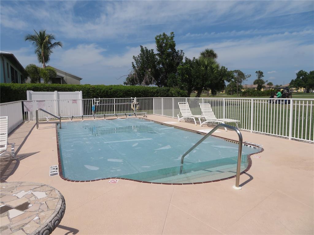 1360 Rio De Janeiro Avenue, Unit 117 Punta Gorda, FL 33983 - Photo 2 of 20 a view of a swimming pool with a patio