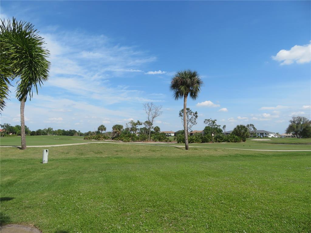 1360 Rio De Janeiro Avenue, Unit 117 Punta Gorda, FL 33983 - Photo 4 of 20 a view of a golf course with a lake
