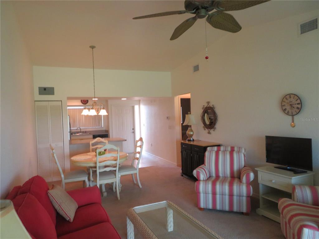 1360 Rio De Janeiro Avenue, Unit 117 Punta Gorda, FL 33983 - Photo 7 of 20 a living room with furniture and a flat screen tv
