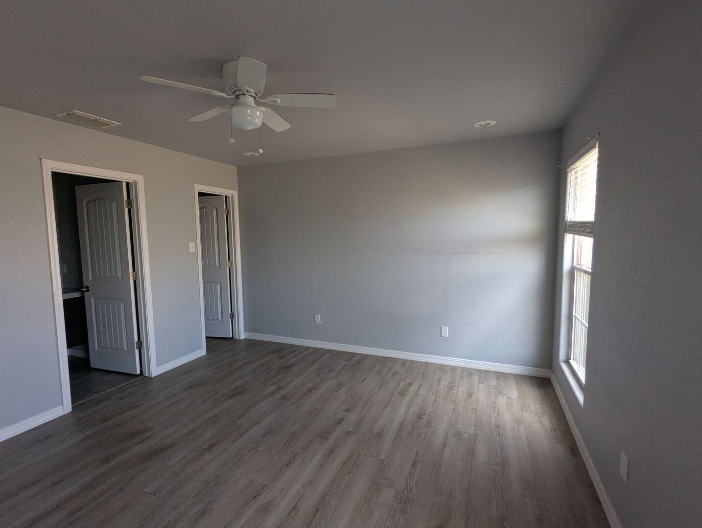 1302 North Clinton Avenue, Unit A & B Lubbock, TX 79416 - Photo 11 of 17 an empty room with wooden floor closet and windows
