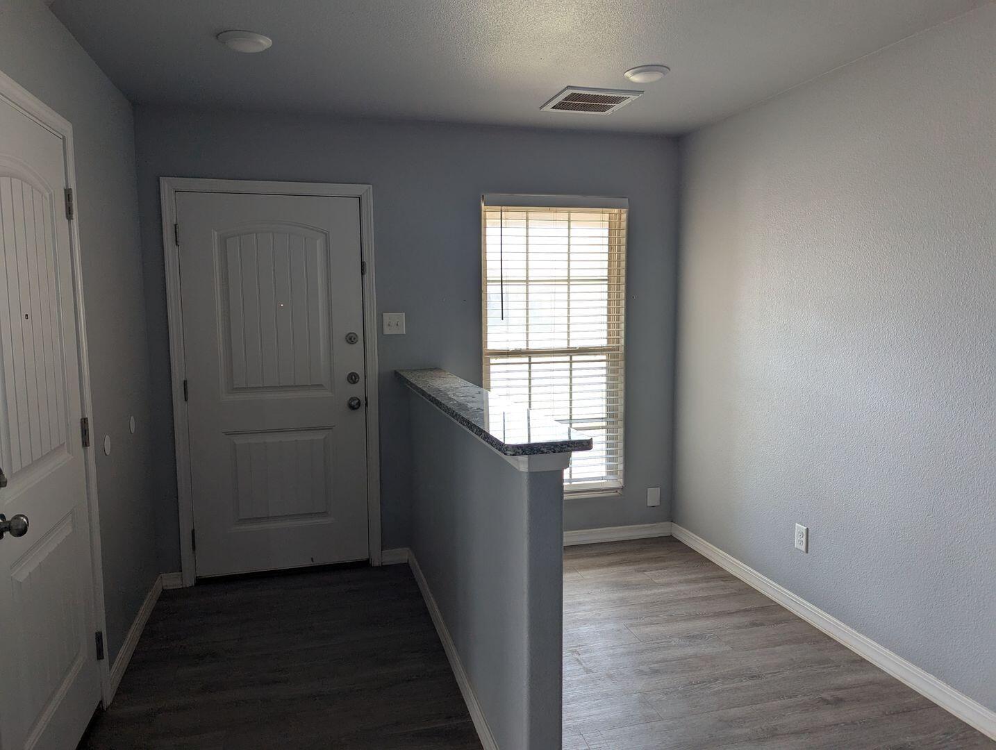 1302 North Clinton Avenue, Unit A & B Lubbock, TX 79416 - Photo 2 of 17 wooden floor in an empty room with a window