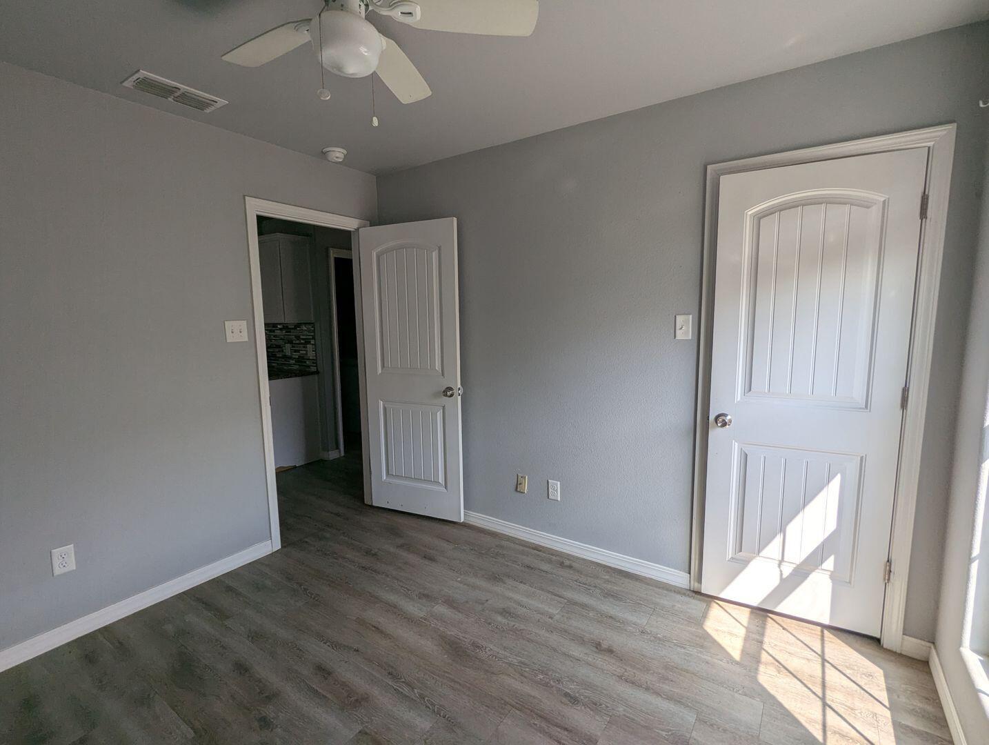 1302 North Clinton Avenue, Unit A & B Lubbock, TX 79416 - Photo 7 of 17 wooden floor in an empty room with a window