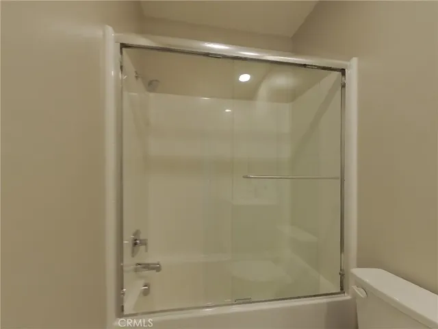 a bathroom with a glass shower door