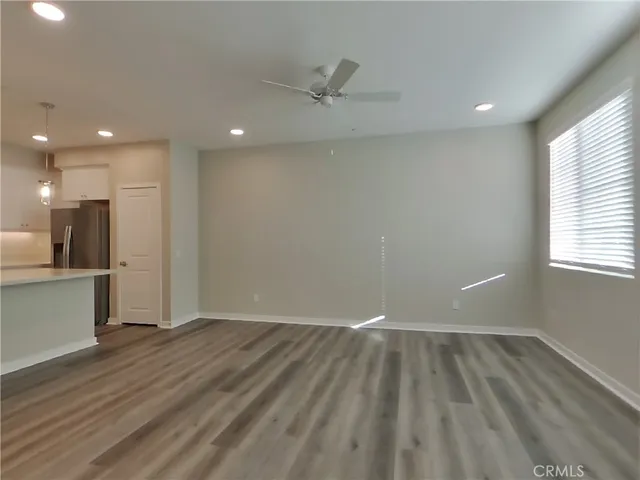 a view of room with window and wooden floor
