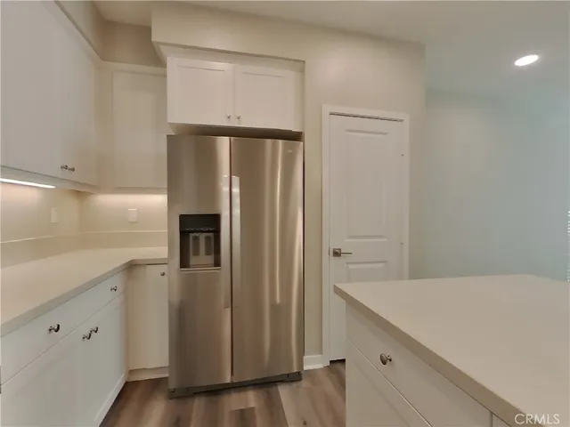a kitchen with a refrigerator and a sink
