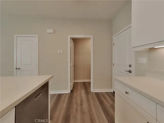 a hallway view with wooden floor