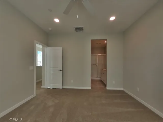 an empty room with an entryway and a hallway