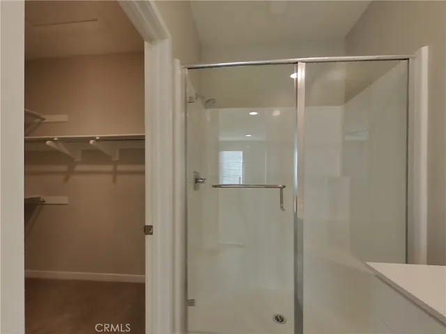 a bathroom with a glass shower door