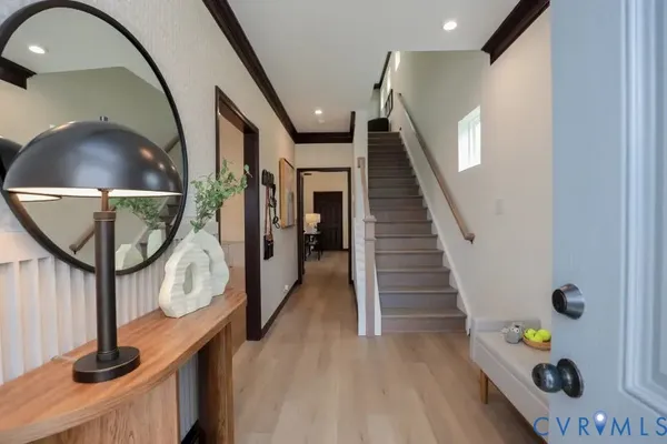 a view of entryway and hall with wooden floor