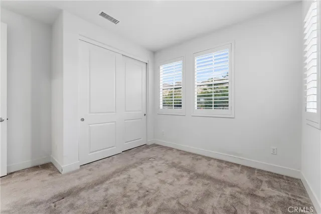 a view of staircase with railing and white walls