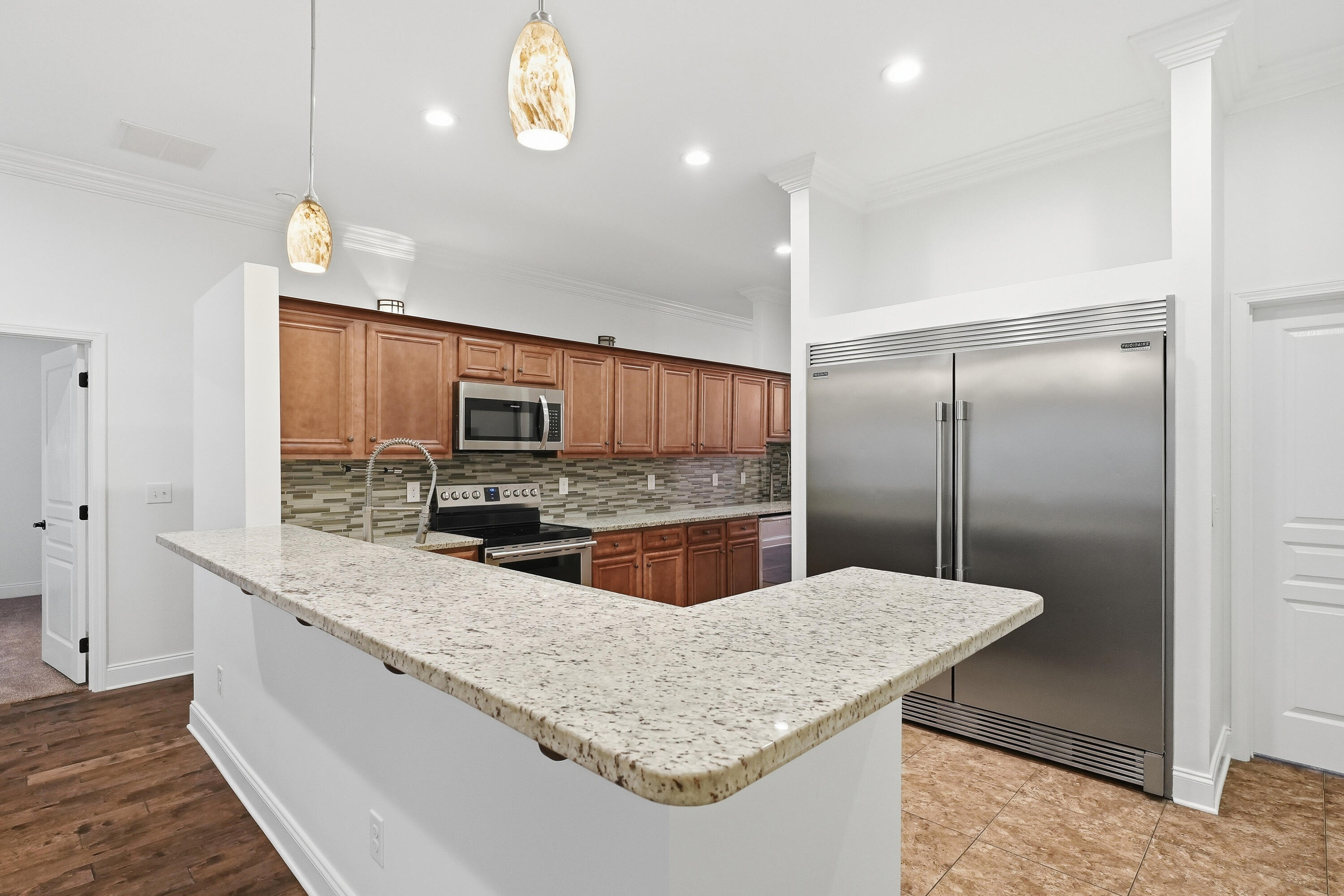 63 2nd Avenue Shalimar, FL 32579 - Photo 14 of 54 a kitchen with stainless steel appliances granite countertop a sink refrigerator and microwave