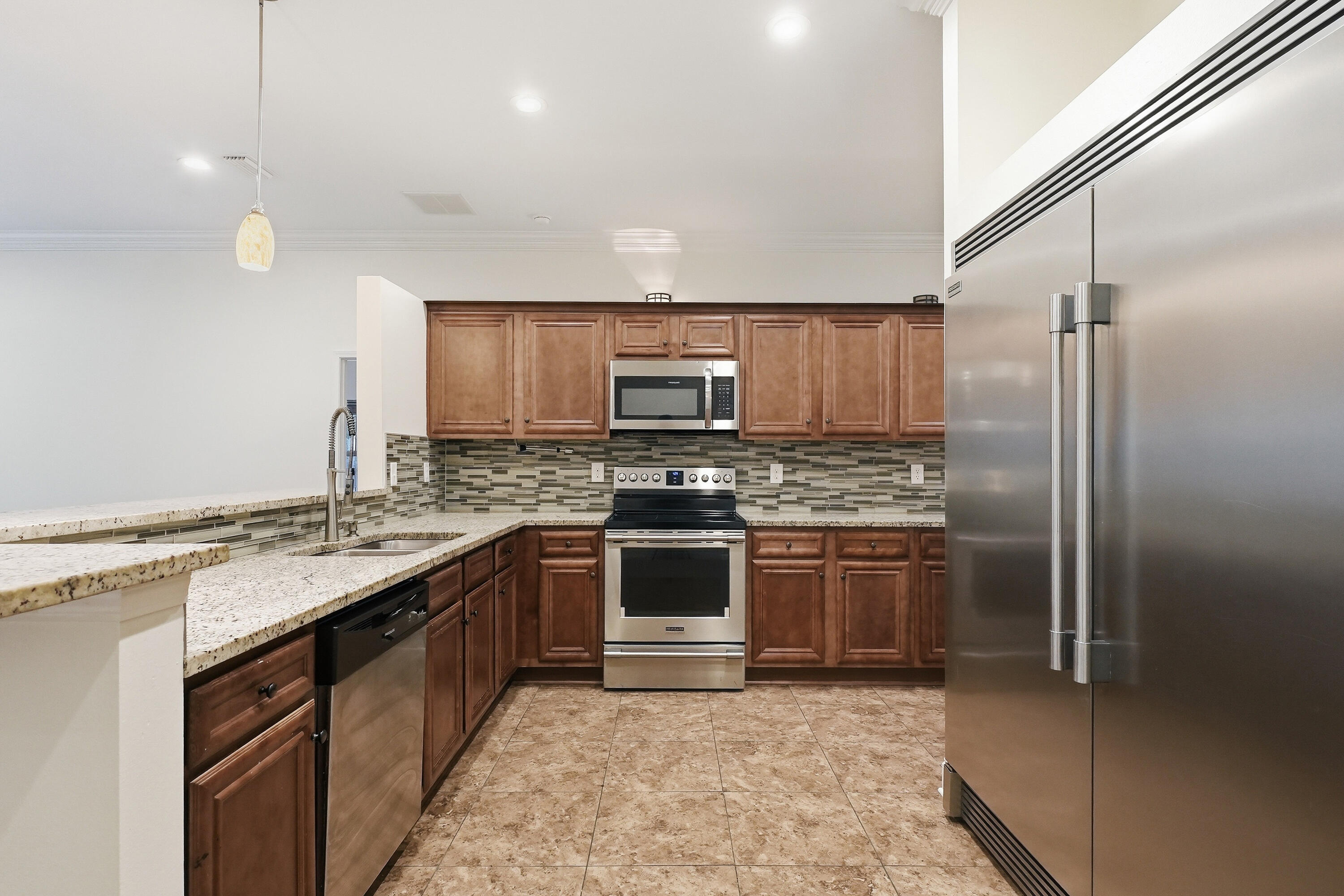 63 2nd Avenue Shalimar, FL 32579 - Photo 17 of 54 a kitchen with stainless steel appliances granite countertop a stove a sink and a refrigerator