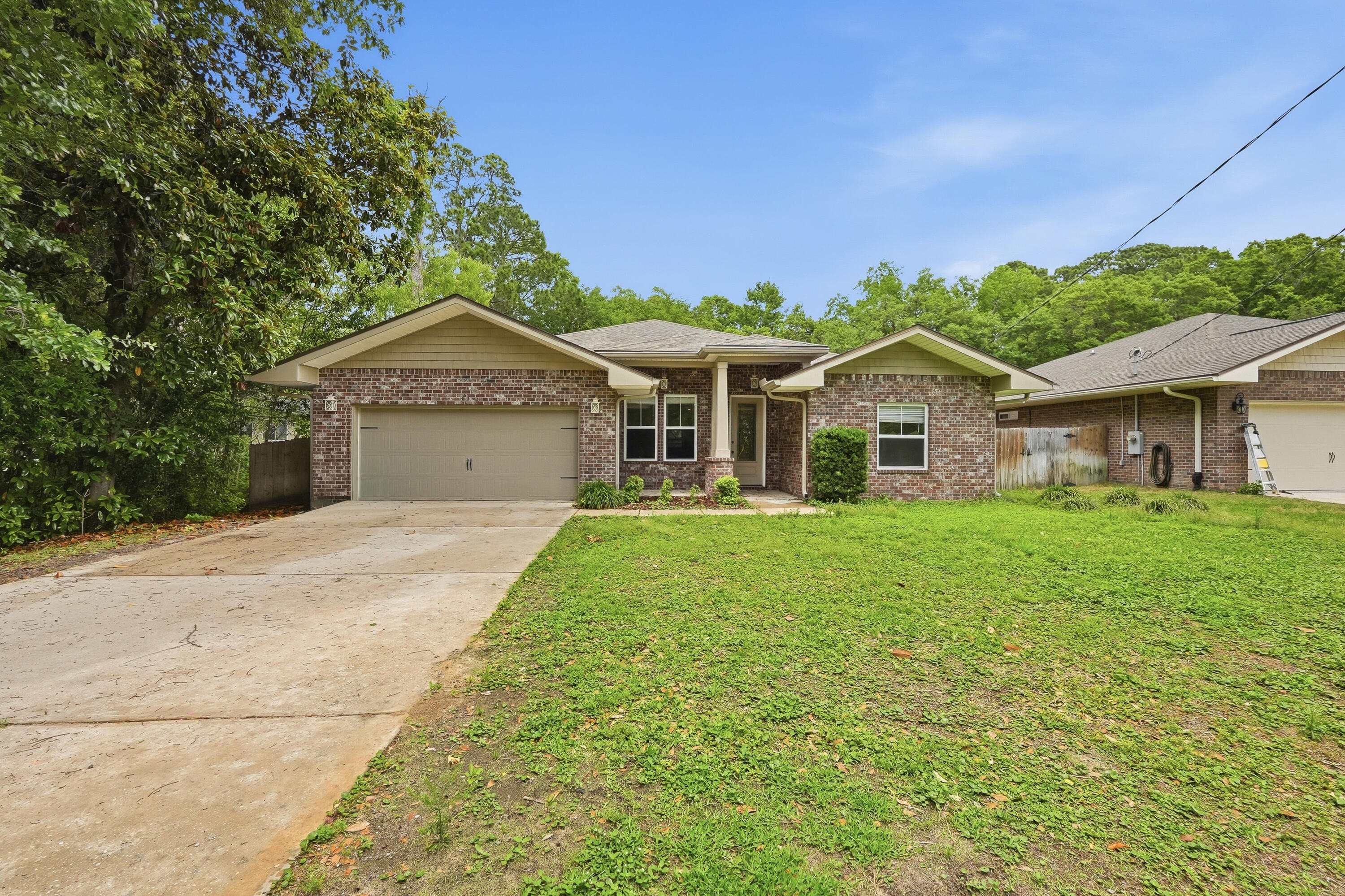 63 2nd Avenue Shalimar, FL 32579 - Photo 2 of 54 a front view of a house with a garden