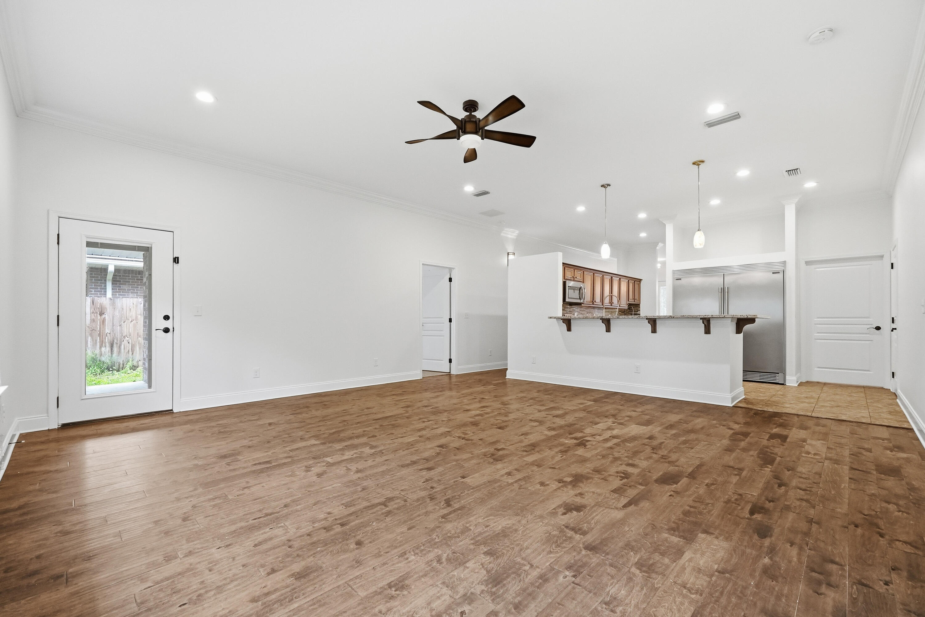 63 2nd Avenue Shalimar, FL 32579 - Photo 10 of 54 a view of a livingroom with a ceiling fan & kitchen space