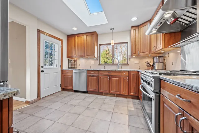 a kitchen with a stove sink and cabinets