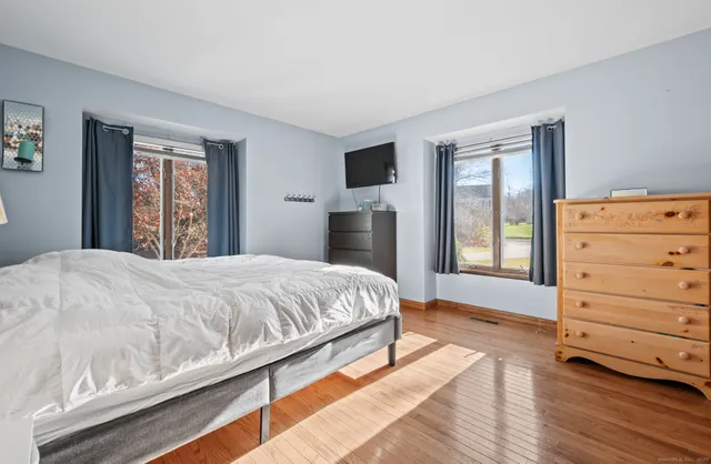 a bedroom with a bed and a dresser