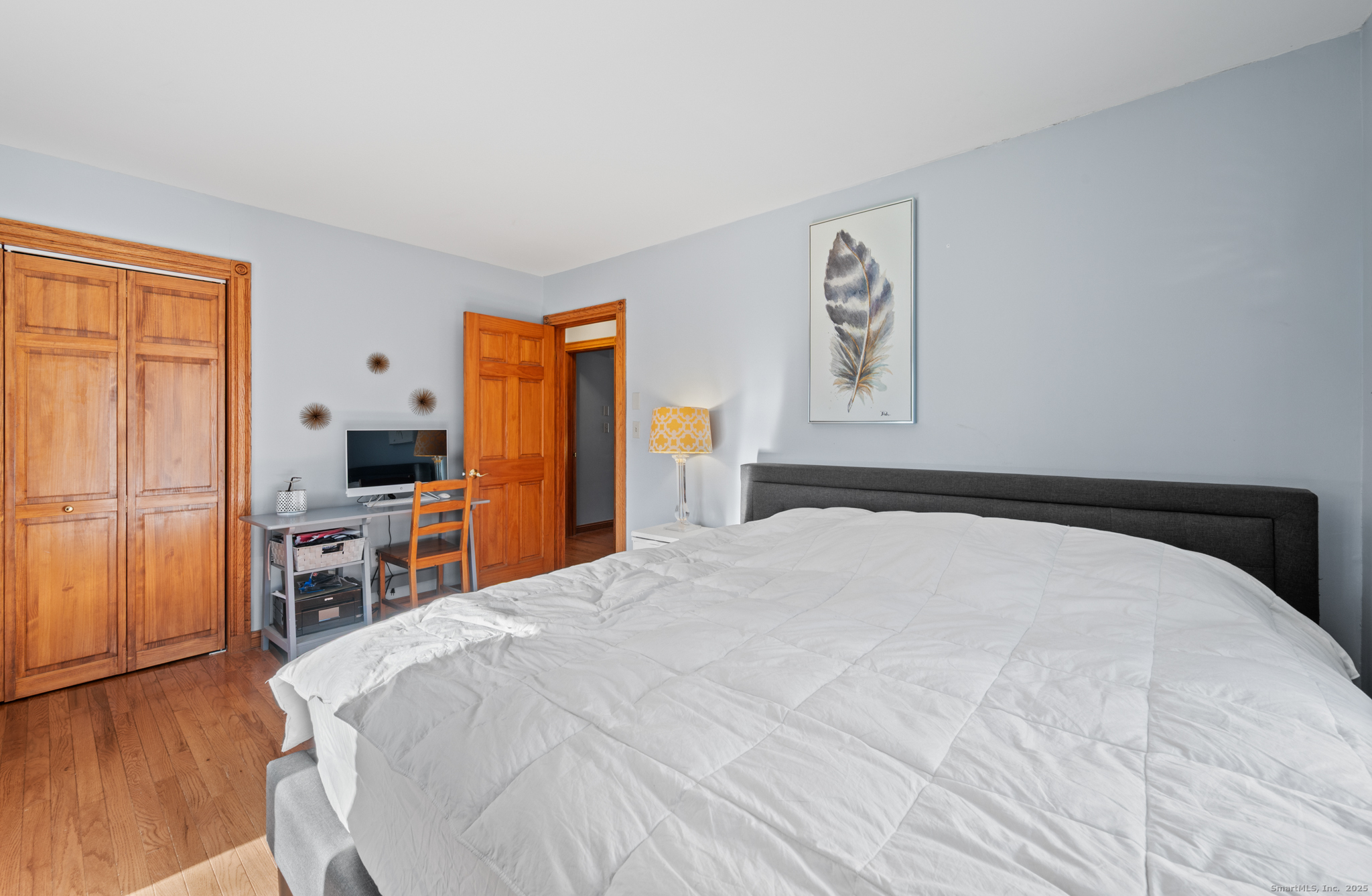 26 Farm View Drive Madison, CT 06443 - Photo 15 of 37 a bedroom with a large bed and a flat tv screen