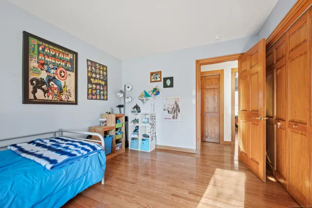 a view of a bedroom with furniture and wooden floor