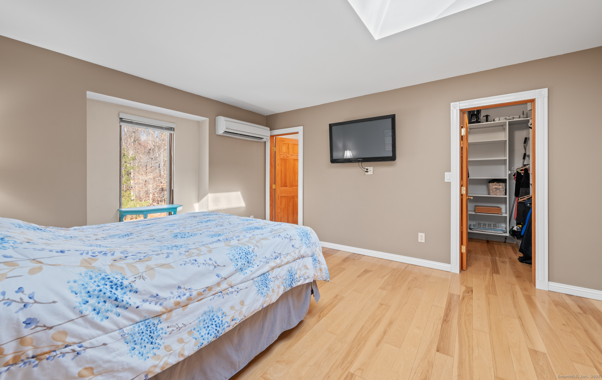 26 Farm View Drive Madison, CT 06443 - Photo 22 of 37 a bedroom with a bed and a flat screen tv