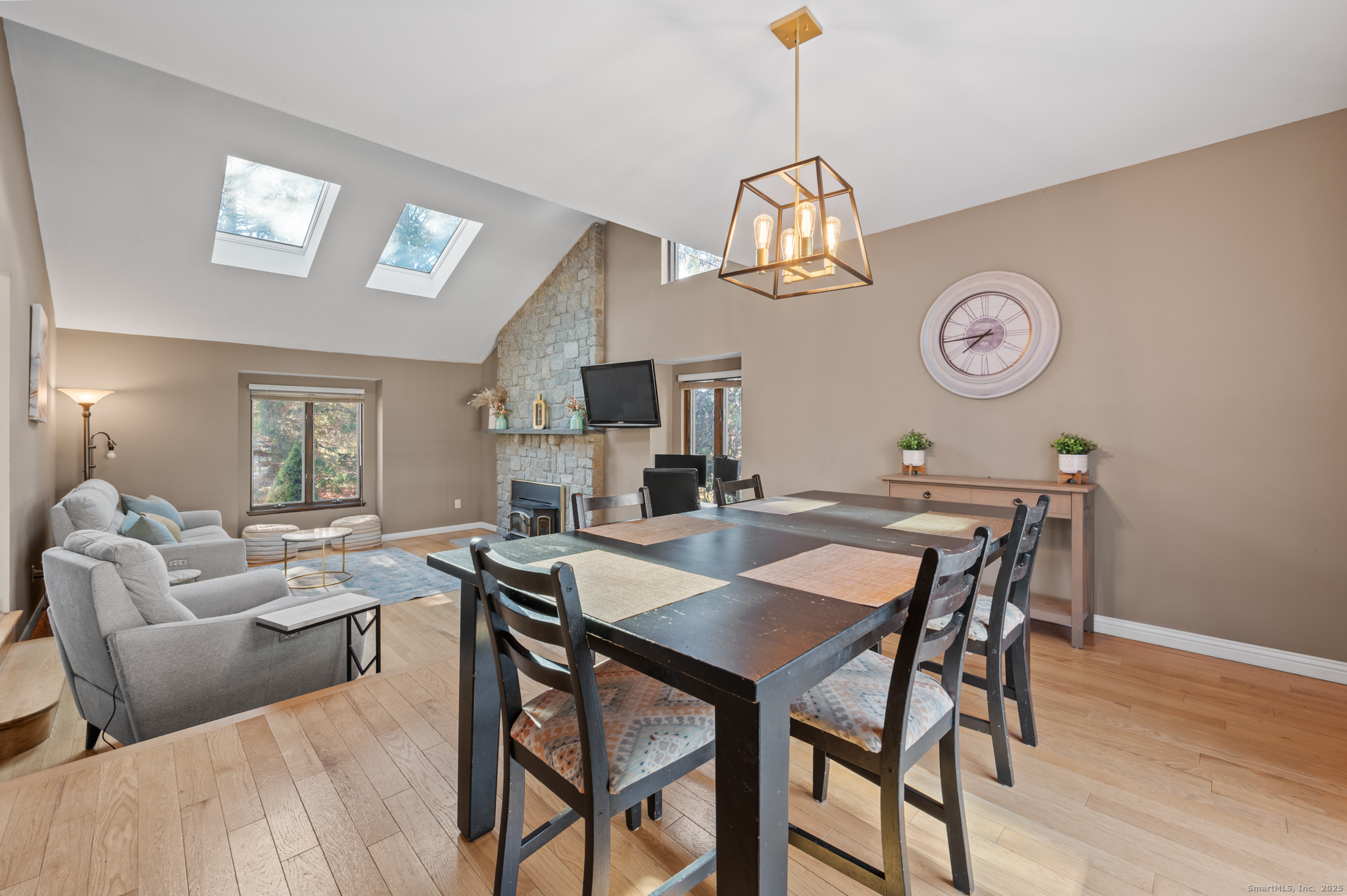 26 Farm View Drive Madison, CT 06443 - Photo 5 of 37 a view of a dining room with furniture wooden floor and a chandelier