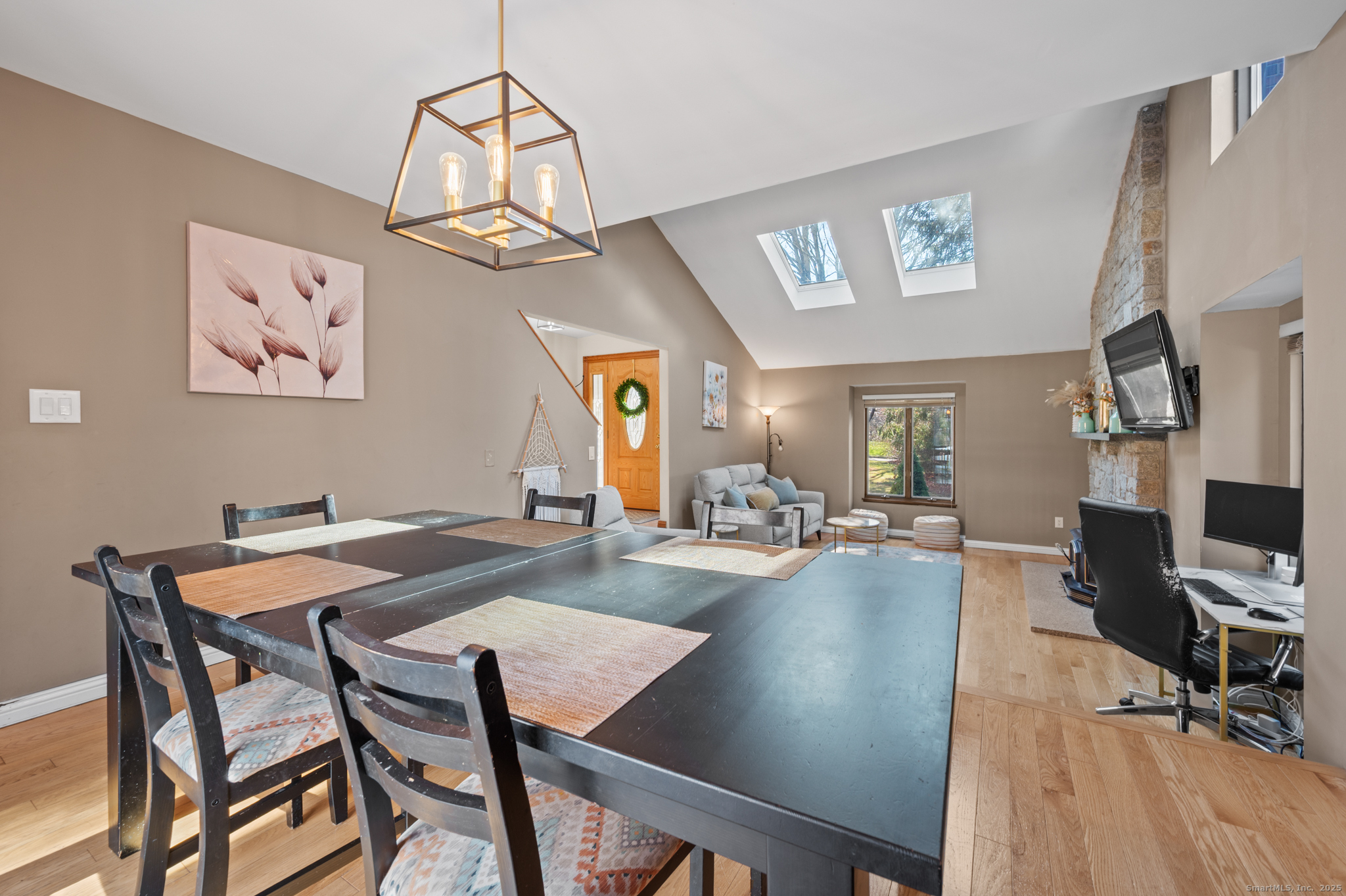 26 Farm View Drive Madison, CT 06443 - Photo 6 of 37 a view of a dining room with furniture a chandelier and wooden floor
