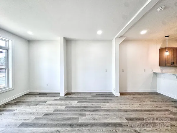 a view of a room with wooden floor and window