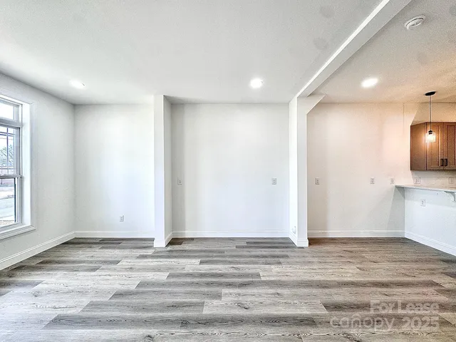 a view of a room with wooden floor and window