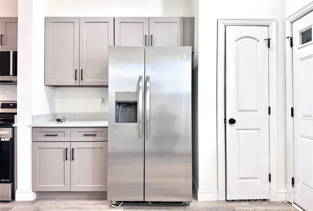 a kitchen with cabinets and stainless steel appliances