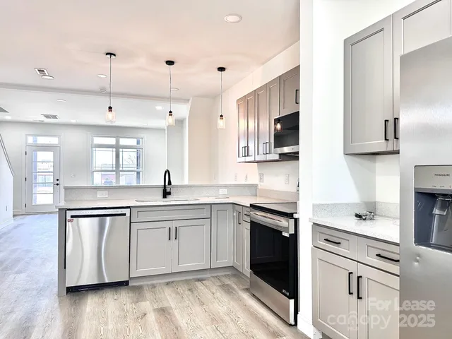 a kitchen with a sink cabinets and window