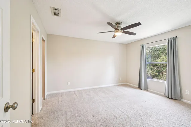 a view of a workspace with furniture and a chandelier fan