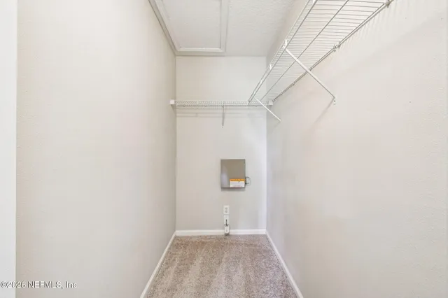 a view of a big room with a ceiling fan