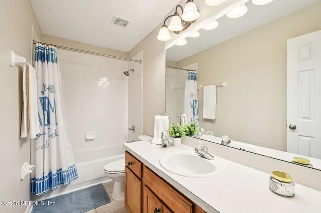 an empty room with closet and a chandelier fan