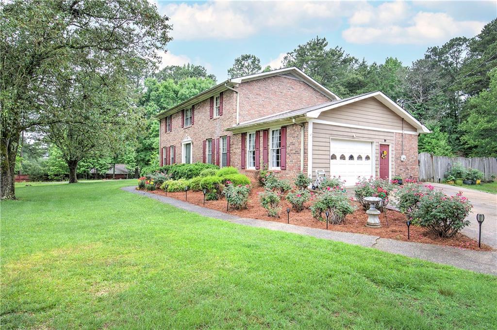 3637 Nebo Road Hiram, GA 30141 - Photo 5 of 63 a front view of a house with a garden